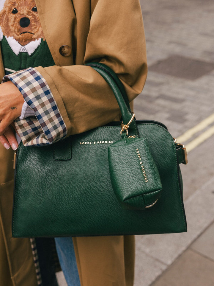 Close-up detail of the Poppy & Peonies Mini Uptown Tote in Heritage Green, featuring the matching accessory tag and gold-tone hardware.