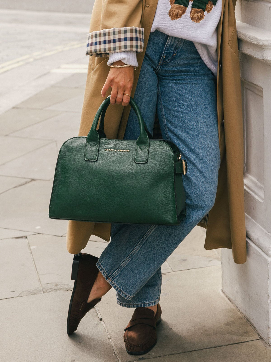 Close-up lower-body shot highlighting the Poppy & Peonies Mini Uptown Tote in Heritage Green carried by the top handles.