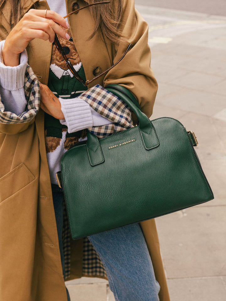 Close-up product-focused shot of the Poppy & Peonies Mini Uptown Tote in Heritage Green carried by the top handles.
