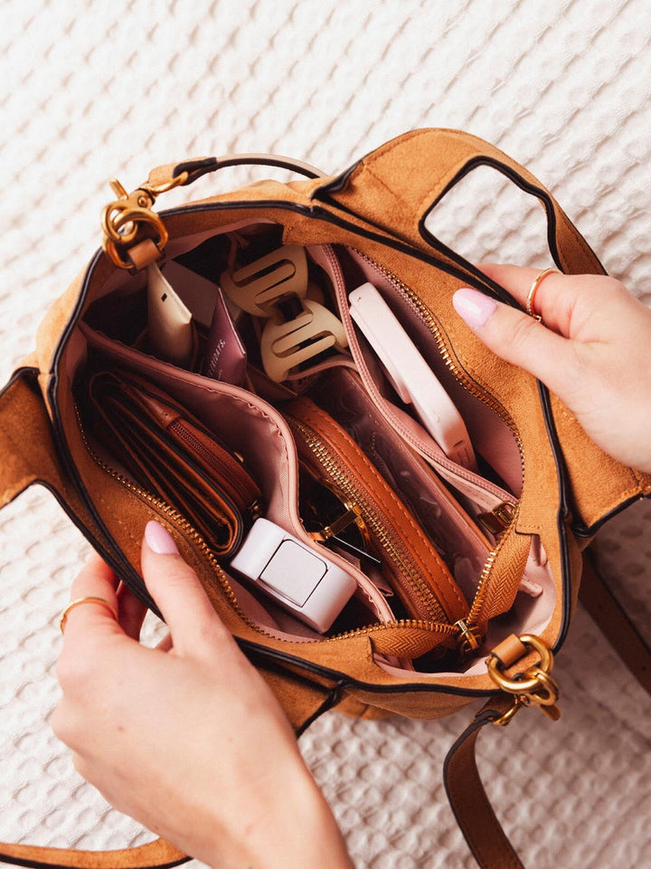 Open view of Poppy & Peonies The Pick Me Up Tote in Cognac Suede, showing the organized interior compartments filled with everyday essentials.