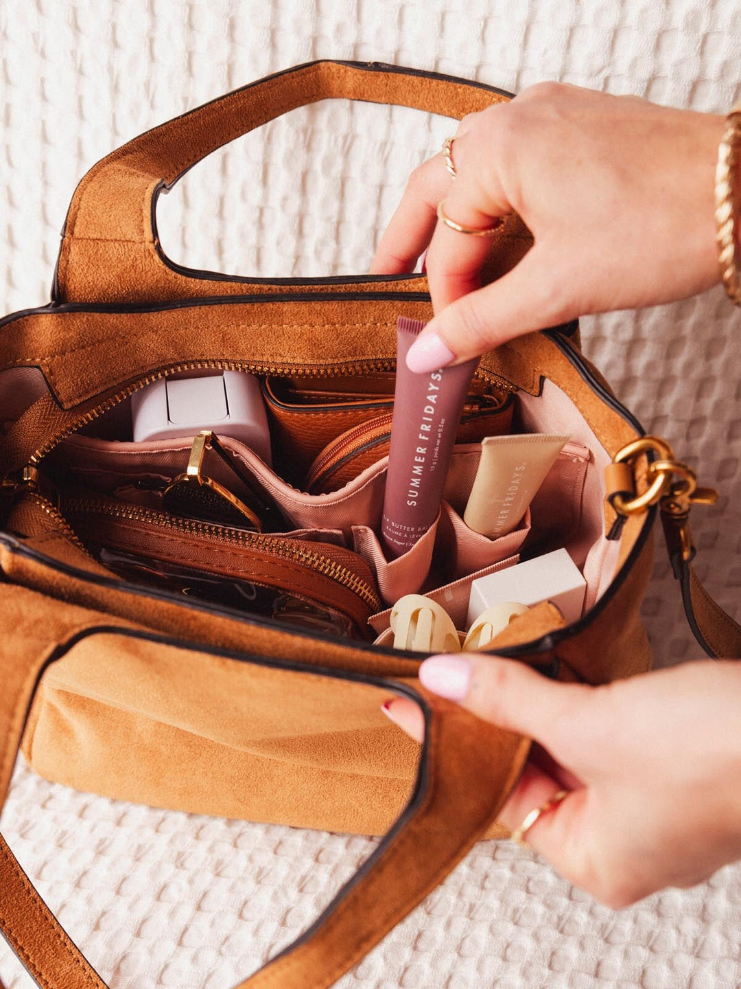 Close-up of Poppy & Peonies The Pick Me Up Tote in Cognac Suede showing the organized interior with pockets and everyday essentials.