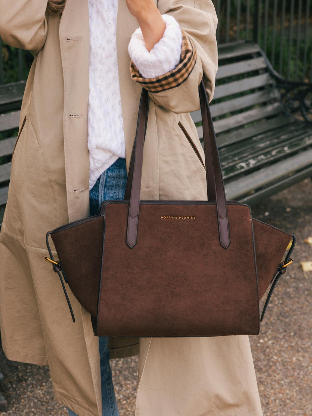 Close-up of Poppy & Peonies Mini Avenue Tote in Espresso Suede carried by the top handles, highlighting its soft suede exterior and smooth vegan leather straps.