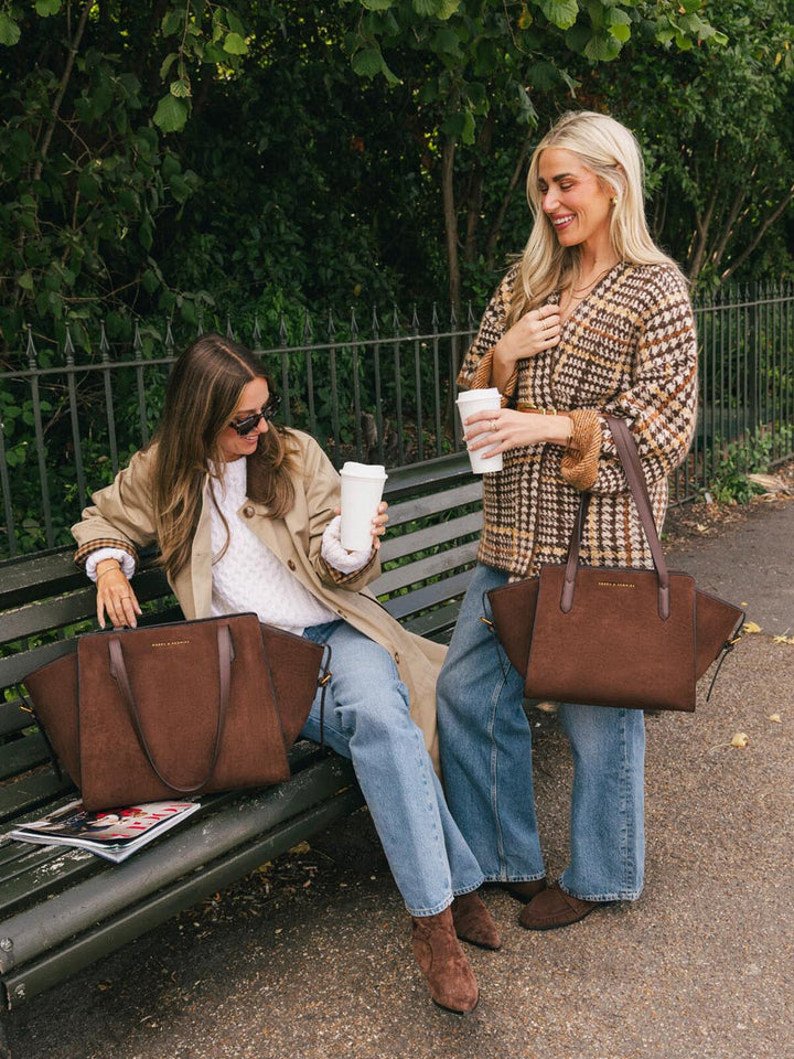 Poppy & Peonies Mini Avenue Tote in Espresso Suede shown during a park outing alongside Avenue tote, highlighting its compact everyday size and rich espresso suede finish.
