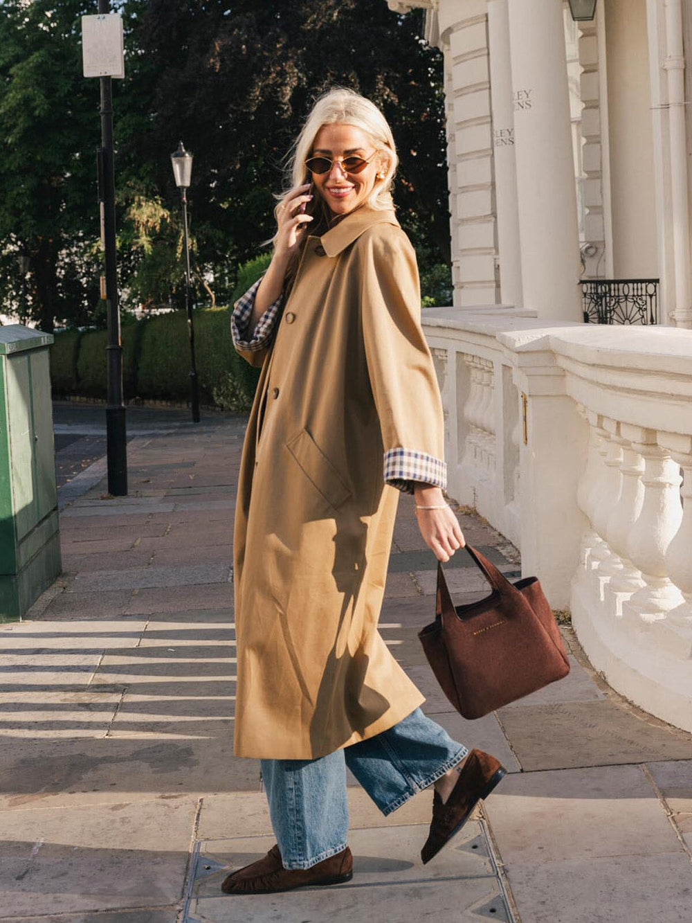 Poppy & Peonies The Pick Me Up Tote in Espresso Suede carried by the top handles during a sunny outdoor outing.