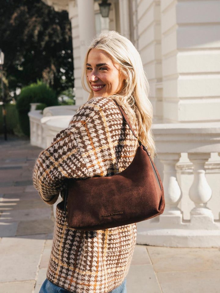 Poppy & Peonies The Sunday Bag in Espresso Suede worn over the shoulder, highlighting the soft suede texture, spacious silhouette and comfortable strap.