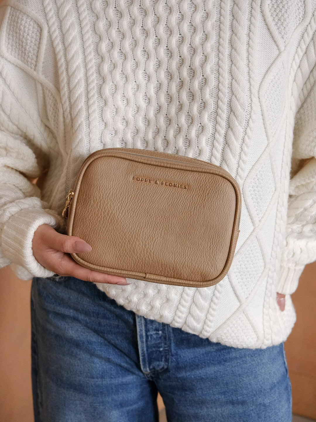 Front view of the Poppy & Peonies Split Organizer in Taupe, showcasing its textured finish, rounded rectangular shape, and subtle gold-tone logo.