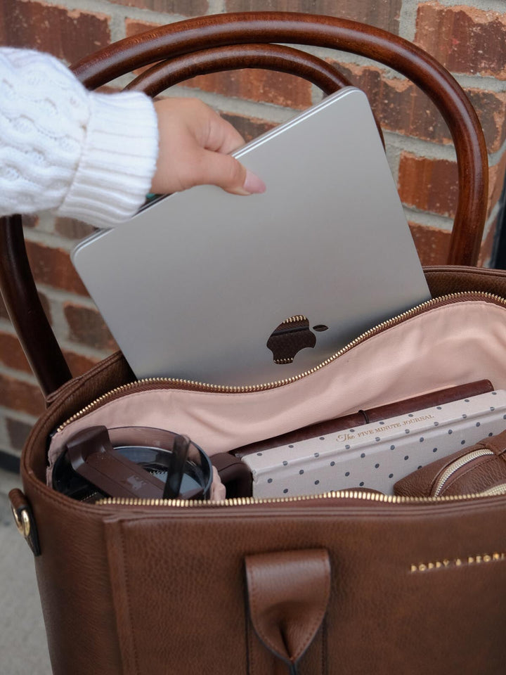 Multitasker Espresso bag shown with a laptop and everyday essentials neatly organized in its spacious, multi-pocket interior.