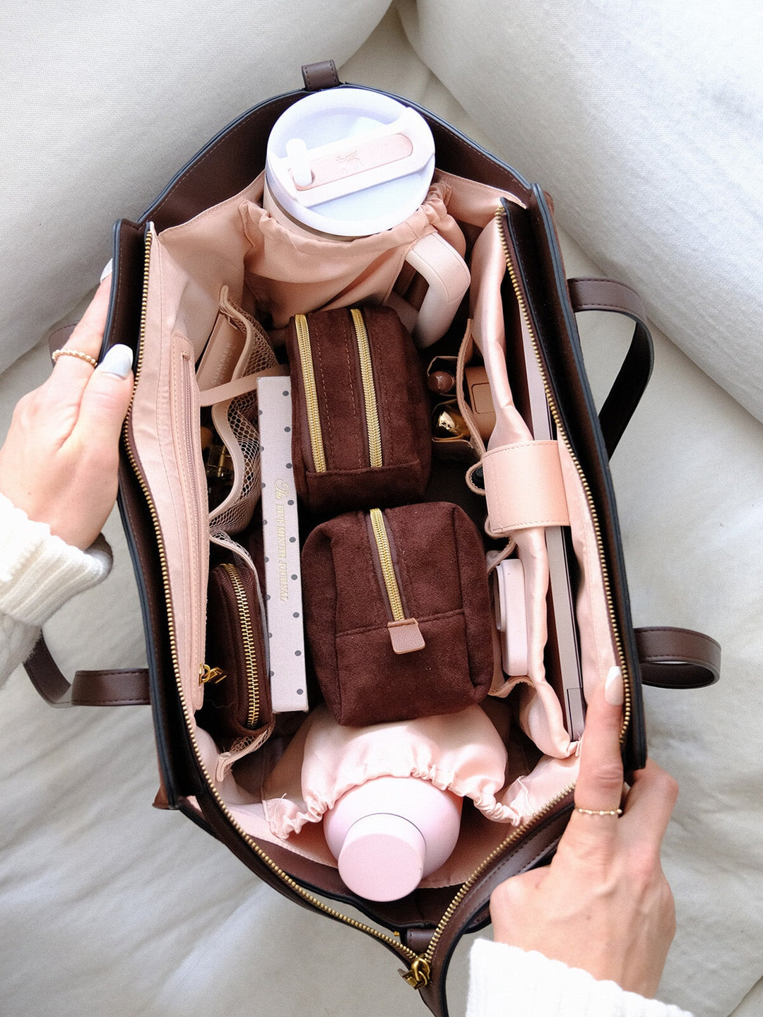 Poppy & Peonies Avenue Tote in Espresso Suede open top view, showcasing the spacious blush interior with organized compartments, zippered pouches, bottle storage and everyday essentials.
