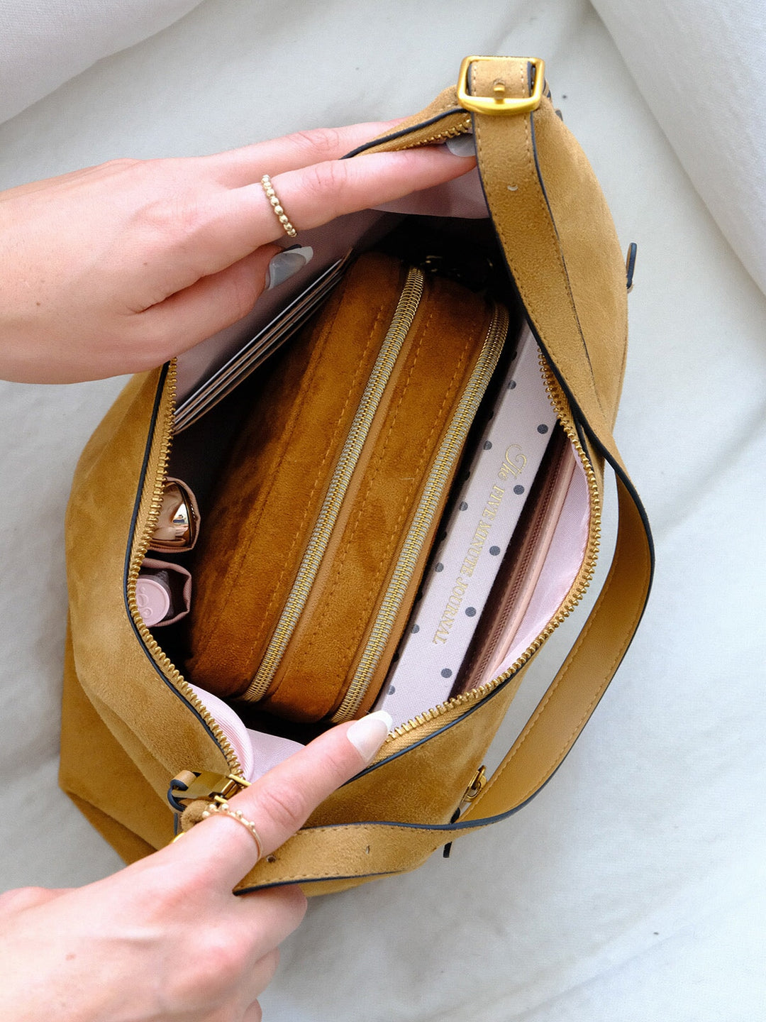 Poppy & Peonies The Sunday Bag in Cognac Suede open top view, showcasing the blush interior, zippered compartment and organized storage for everyday essentials.