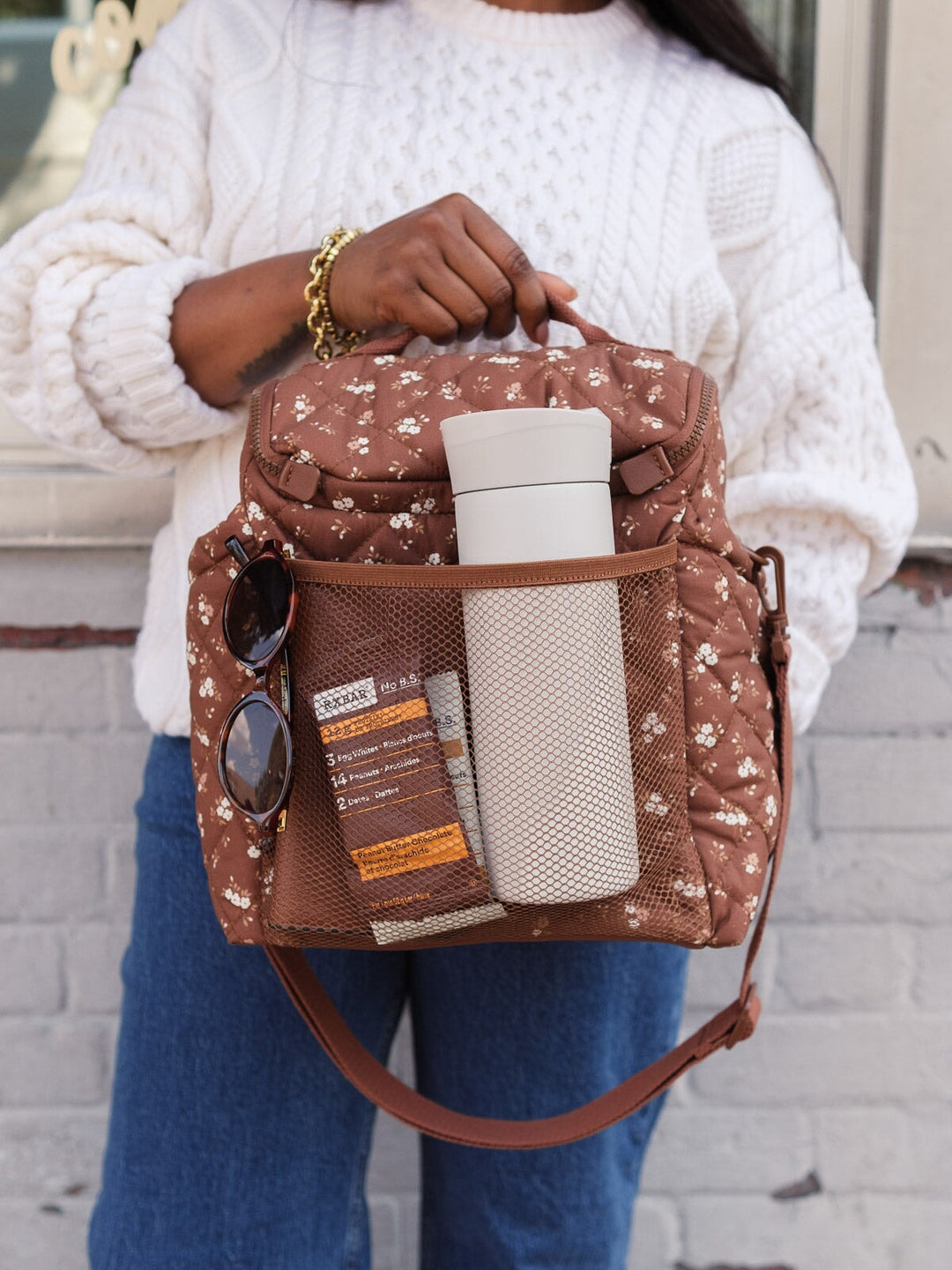 Poppy & Peonies The Lunch Date in Brown Patchwork with a water bottle and essentials stored in the exterior mesh pockets.