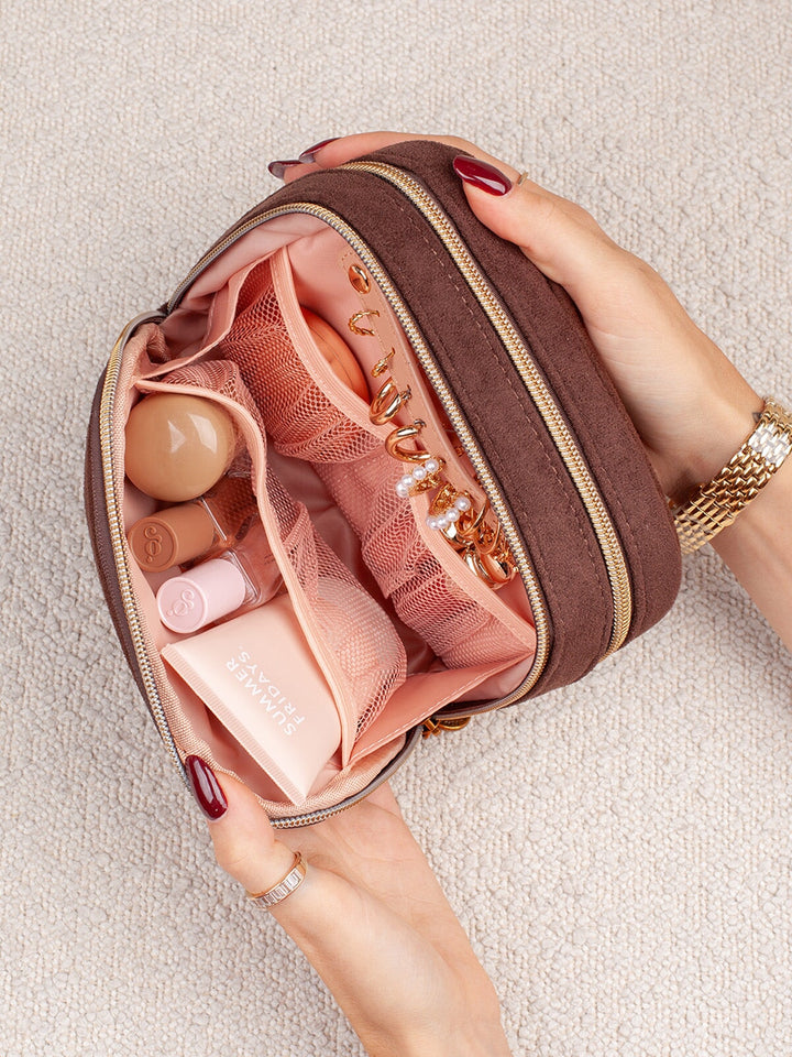 Close-up of Poppy & Peonies Pretty Connected Case in Espresso Suede, highlighting the blush-pink interior with mesh pockets and organized storage for beauty products and small essentials.