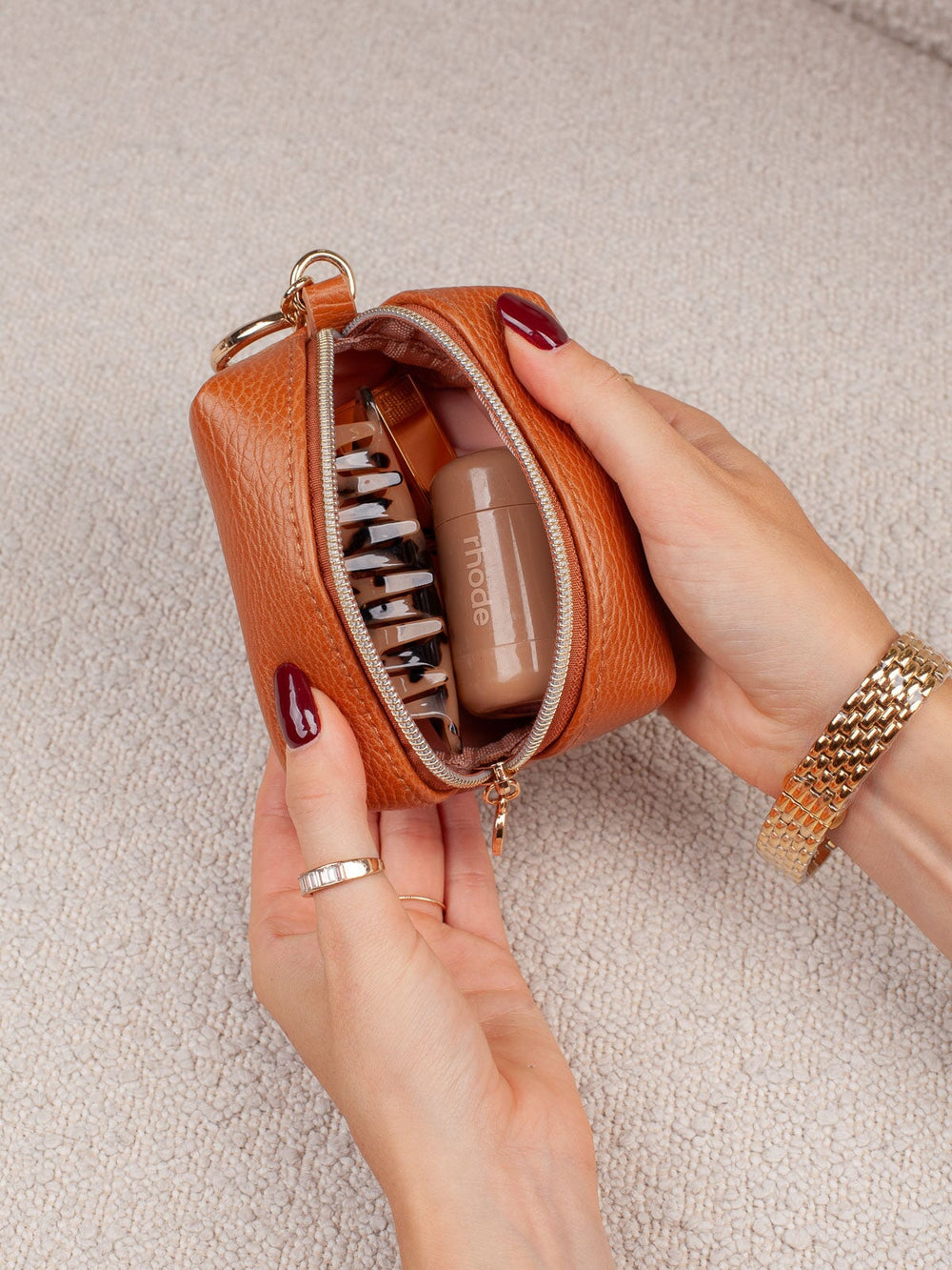 Close-up of the Poppy & Peonies Tag Along Charm in Cognac opened to show its compact interior storage 