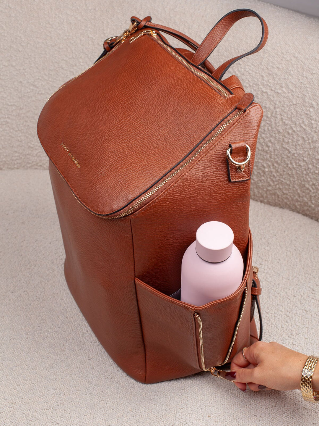 Poppy & Peonies Carryall Backpack in Chestnut with water bottle in exterior side pocket.