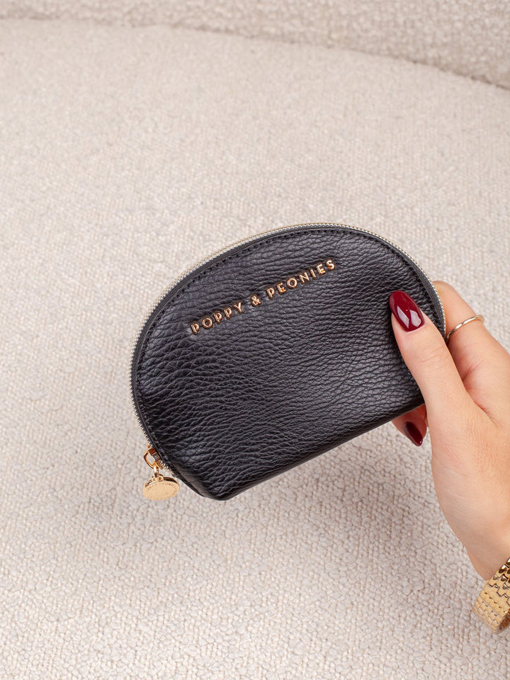 Interior lifestyle shot of the Knot Today Jewelry Case in Black, shown open to highlight its soft blush lining and divided compartments for organizing rings, earrings, necklaces, and other small jewelry pieces.