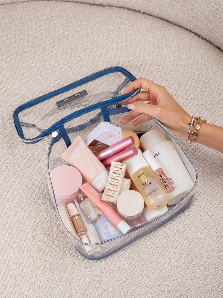 Poppy & Peonies Getaway Cosmetic Set in Navy Patchwork clear cosmetic case filled with beauty essentials.