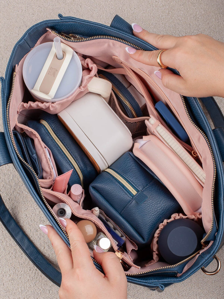 Overhead lifestyle shot of the Multitasker in Navy, highlighting the roomy interior and multiple compartments for keeping essentials organized and easily accessible.