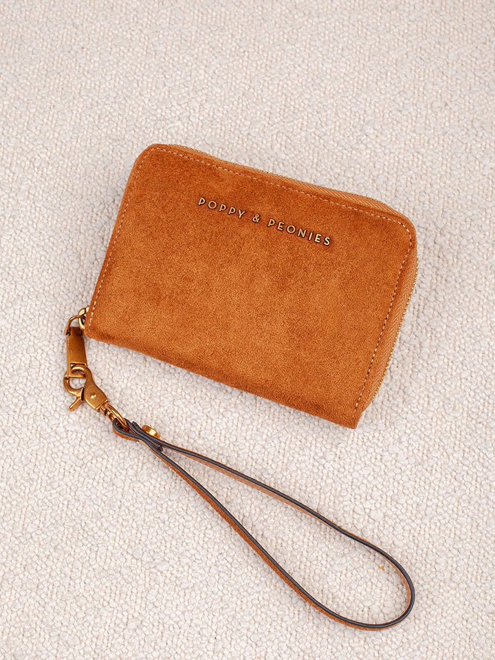 Poppy & Peonies The Grab and Go Wallet in Cognac Suede product view, featuring a zip-around closure, detachable wrist strap and gold-tone hardware.