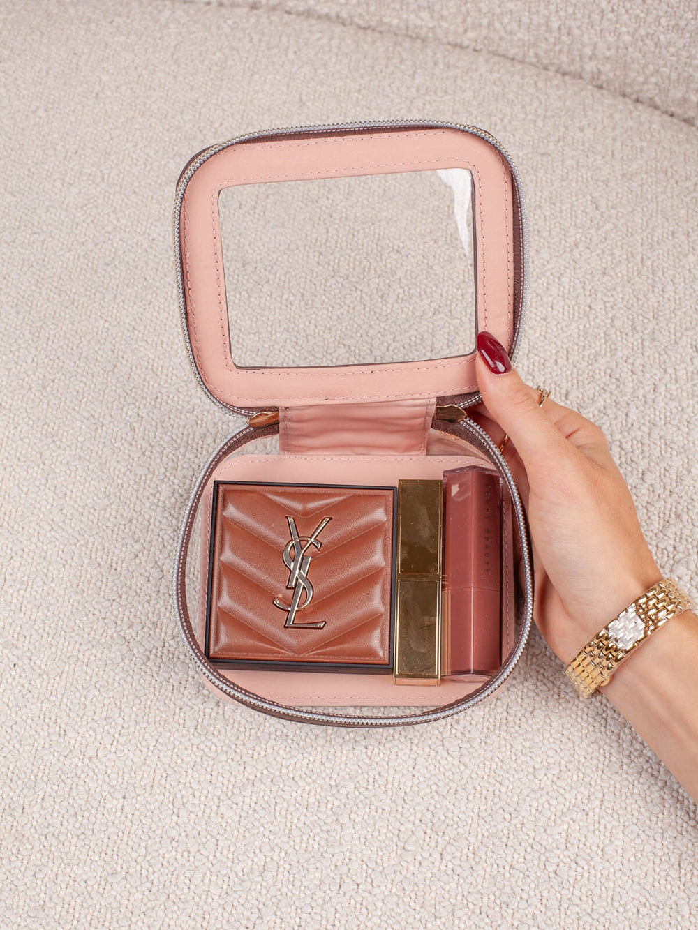 Interior lifestyle shot of the Mini I See You in Espresso, shown open and filled with beauty essentials. Highlights the clear-view lid, compact interior storage, and easy visibility of everyday cosmetics and accessories.