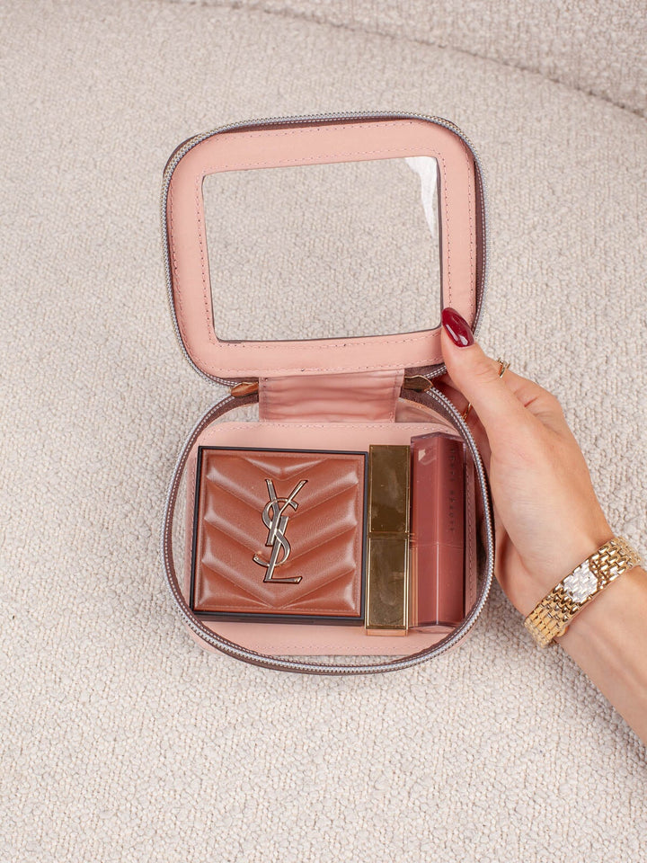 Interior lifestyle shot of the Mini I See You in Espresso, shown open and filled with beauty essentials. Highlights the clear-view lid, compact interior storage, and easy visibility of everyday cosmetics and accessories.