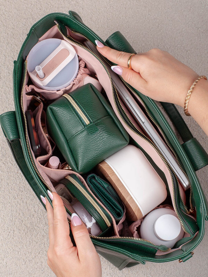Top-down lifestyle view of the Small Heritage in Green, showcasing its generous capacity with organized storage for a tumbler, pouches, and everyday essentials.