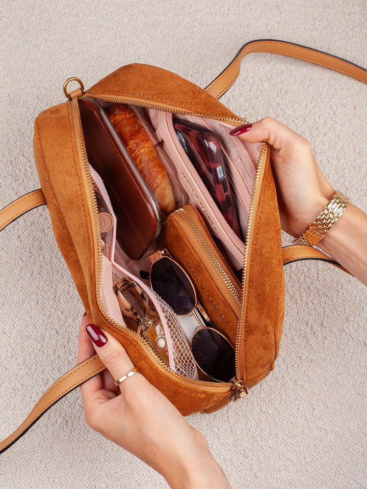 Close-up of Poppy & Peonies The Friday Satchel in Cognac Suede open interior, showcasing its organized storage compartments and everyday essentials.