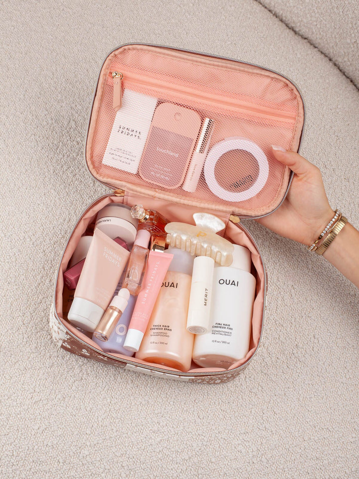 Interior lifestyle shot of the Small Hook Me Up in Brown Patchwork, shown open and packed with beauty essentials to highlight its storage capacity and organization.