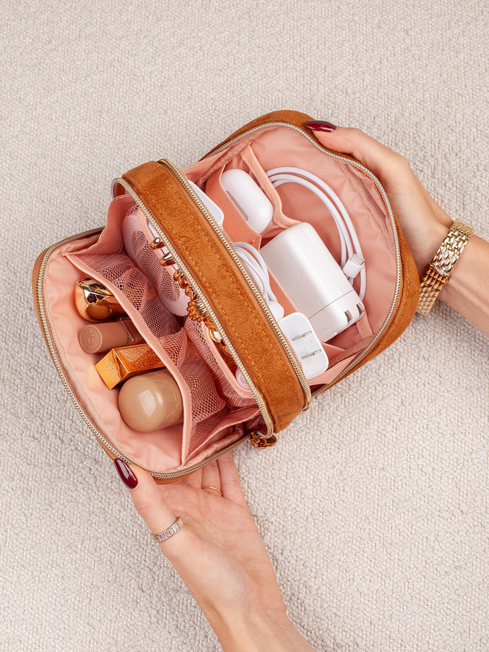 Open view of Poppy & Peonies Pretty Connected Case in Cognac Suede, showing organized compartments filled with tech accessories, cables and small essentials.