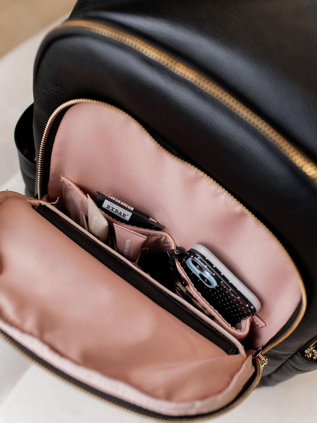 Open front pocket of a black backpack