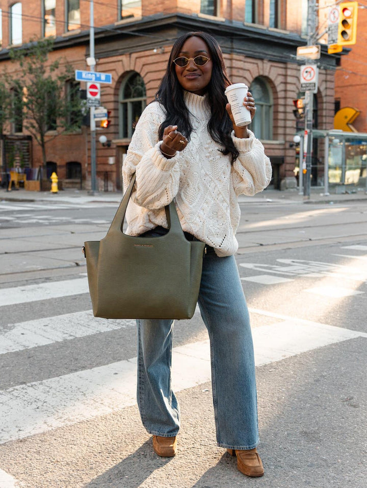 Poppy & Peonies The Companion Tote in Olive lifestyle view, showcasing its roomy everyday silhouette and top-handle carry.
