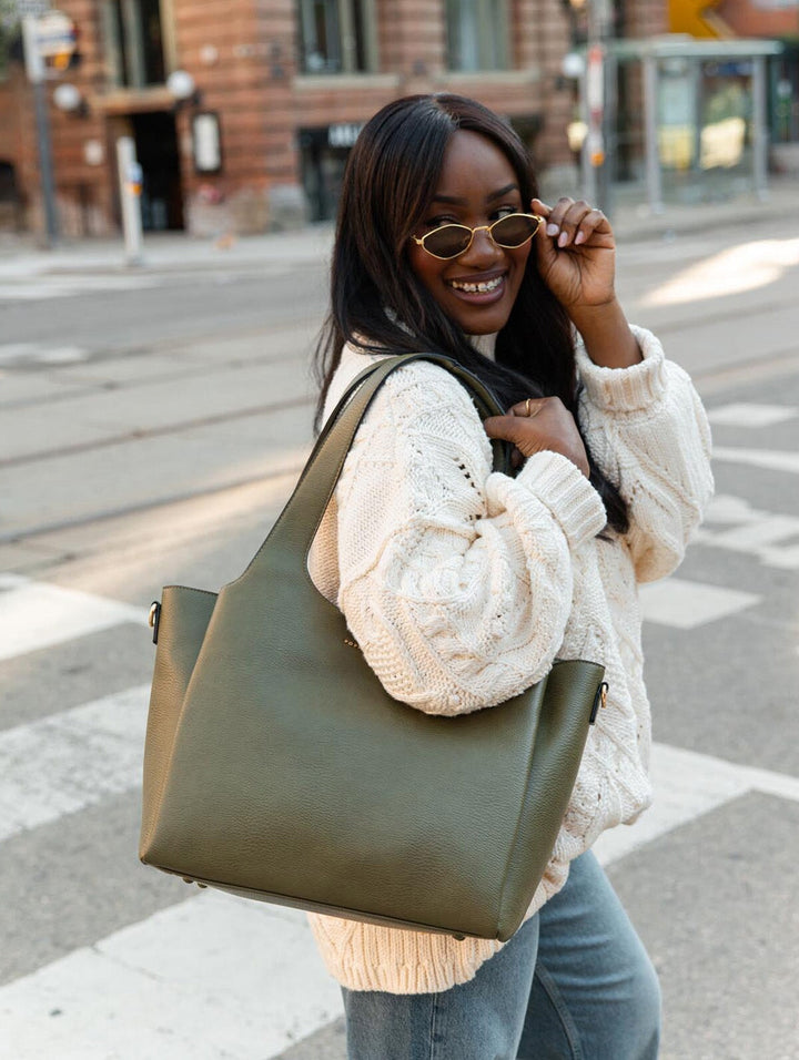 Poppy & Peonies The Companion Tote in Olive lifestyle close-up, showcasing its spacious silhouette worn over the shoulder.