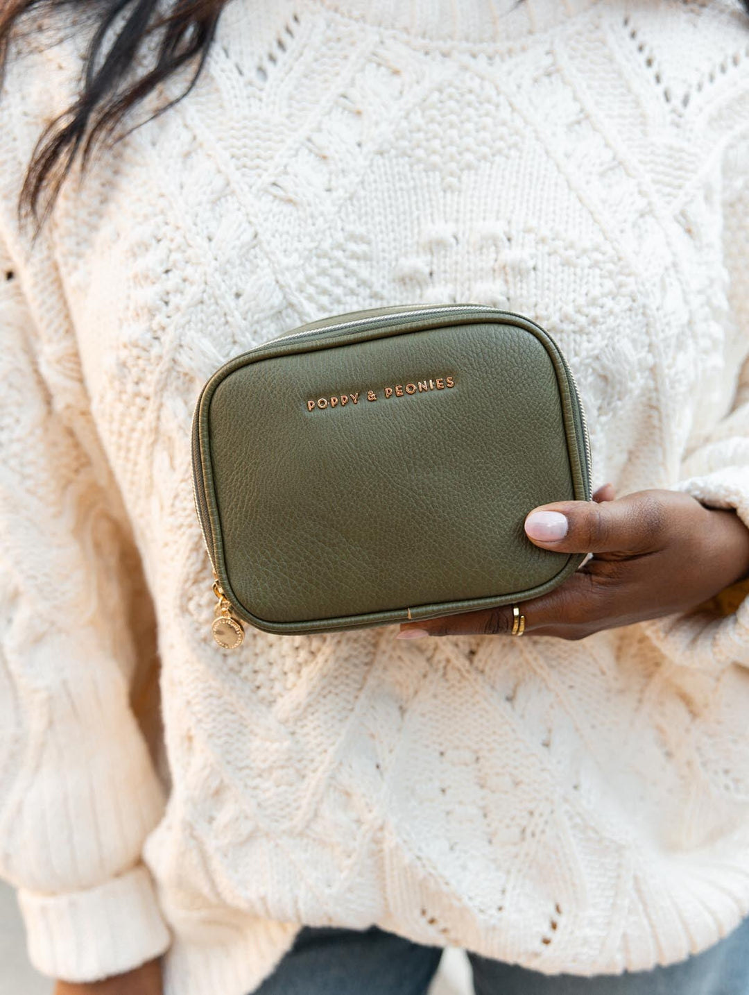 Poppy & Peonies Pretty Connected Case in Olive lifestyle close-up, highlighting its structured zip-around design and gold-tone hardware.