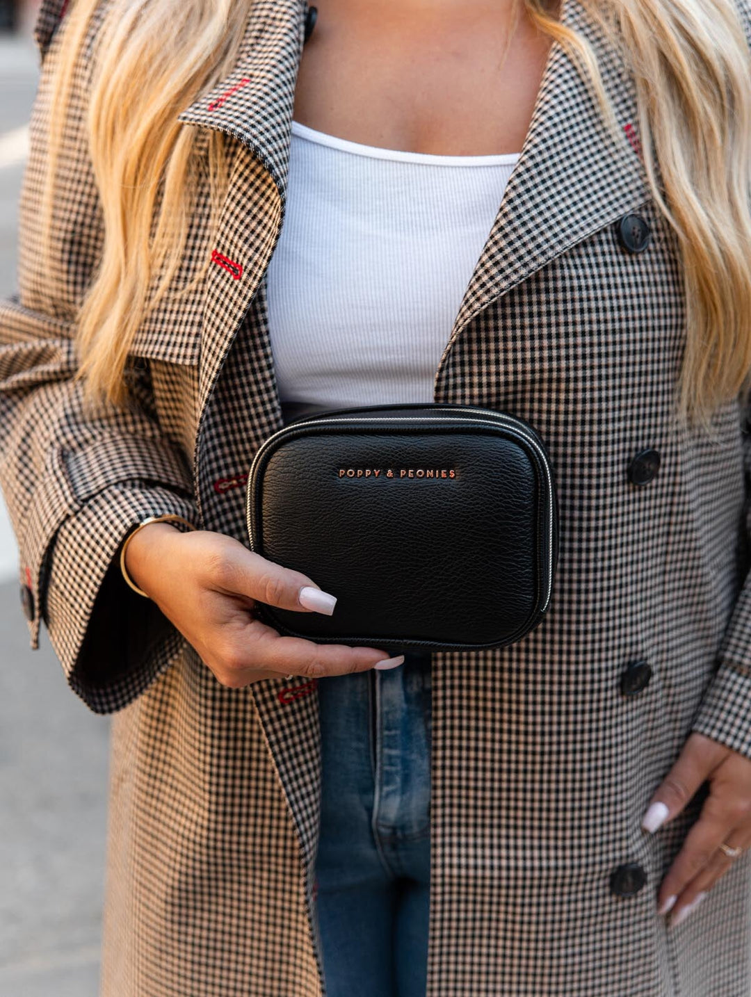 Poppy & Peonies Pretty Connected Case in Black lifestyle front view, showcasing its compact silhouette and signature gold-tone logo.