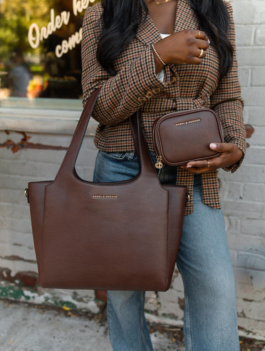Poppy & Peonies The Companion Tote and Pretty Connected Case in Espresso, styled together in a lifestyle view featuring rich brown vegan leather and signature gold-tone logos.