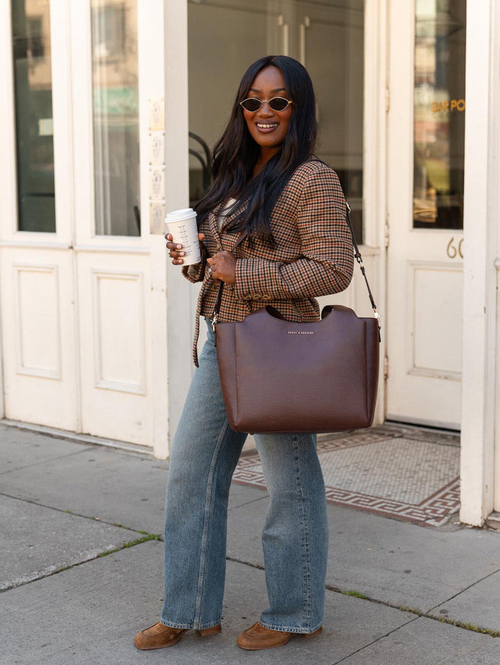 Poppy & Peonies The Companion Tote in Espresso carried at the side, showcasing its spacious structured silhouette.