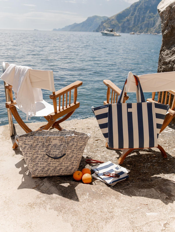 Two wooden chairs with coastal inspired tote bags