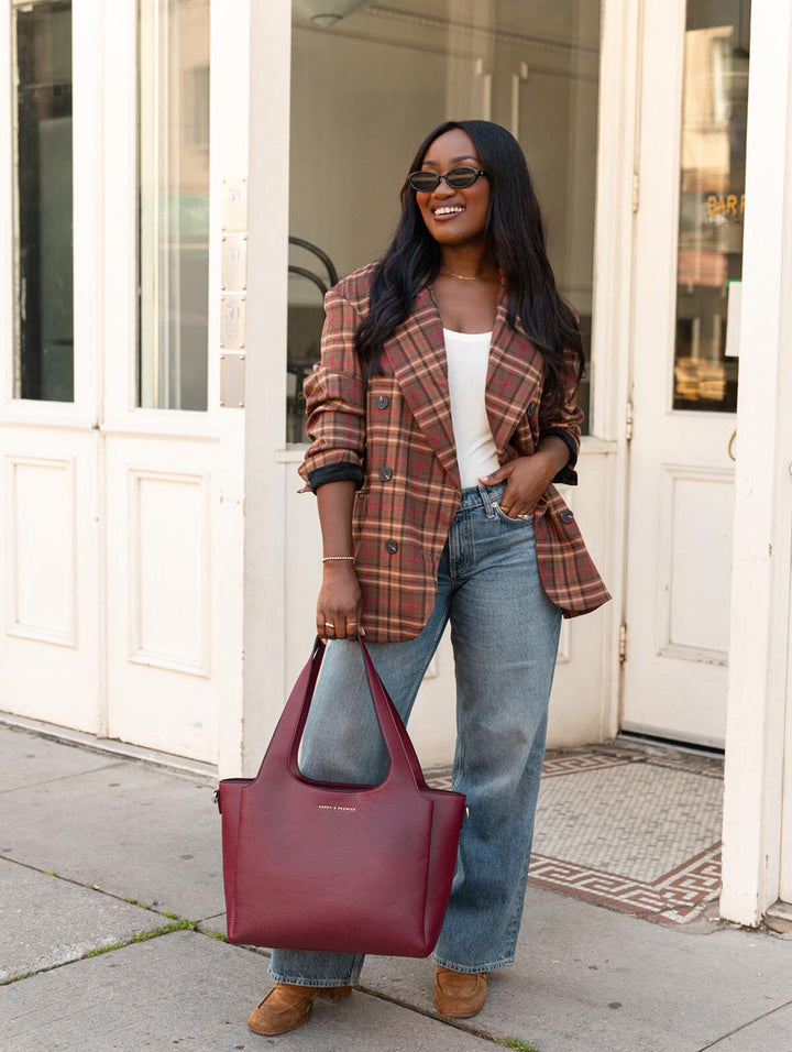 Poppy & Peonies The Companion Tote in Berry carried by the top handles, showcasing its versatile everyday size.