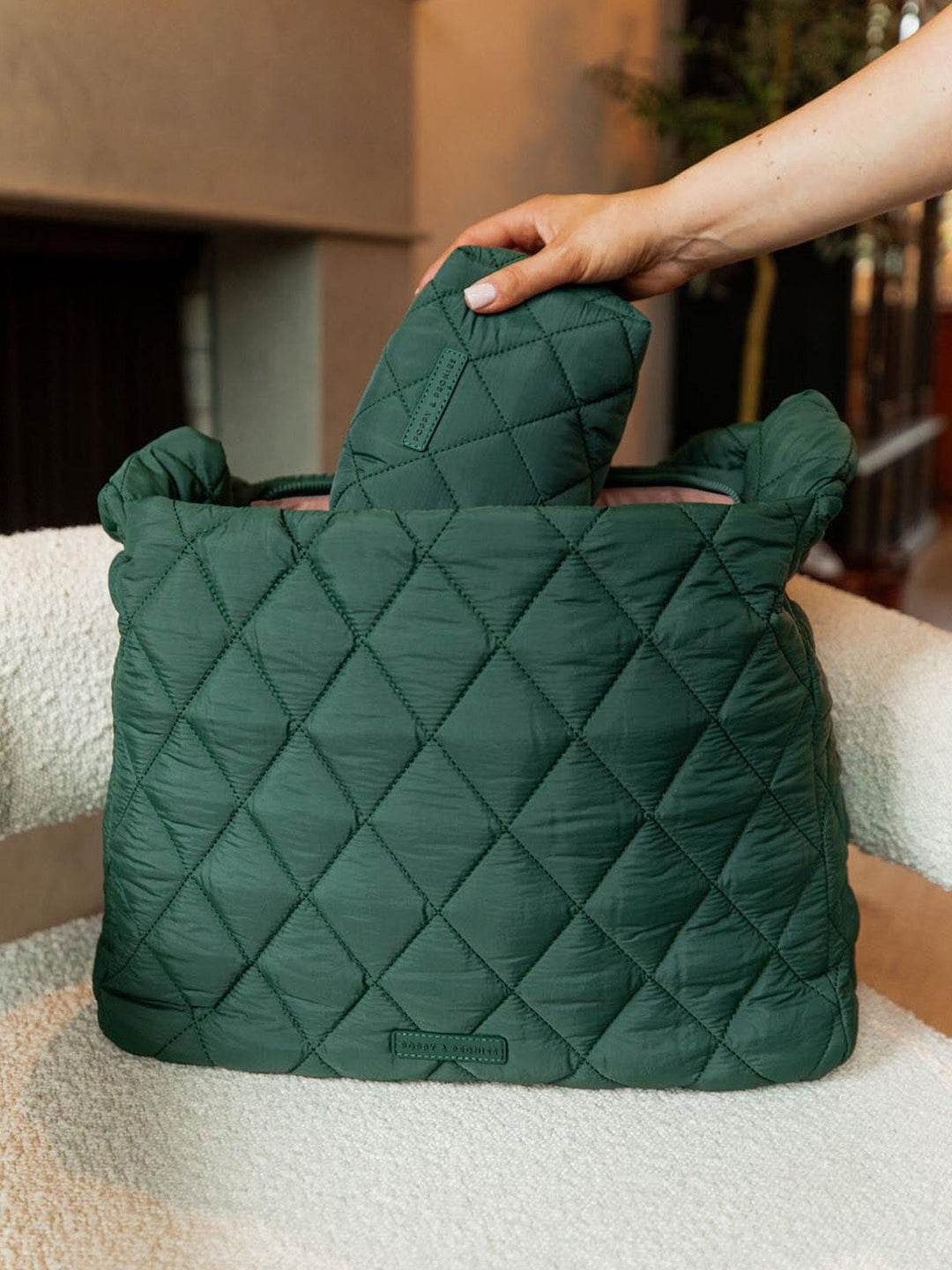 Green quilted handbag on a chair