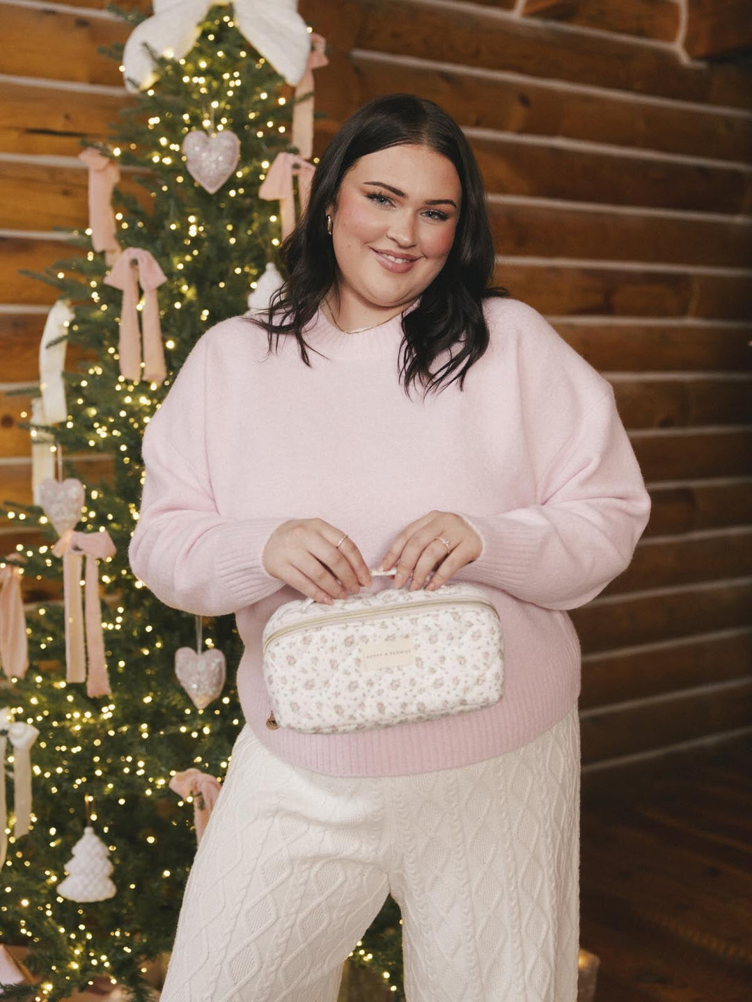 Woman holding a floral patterned cosmetic bag
