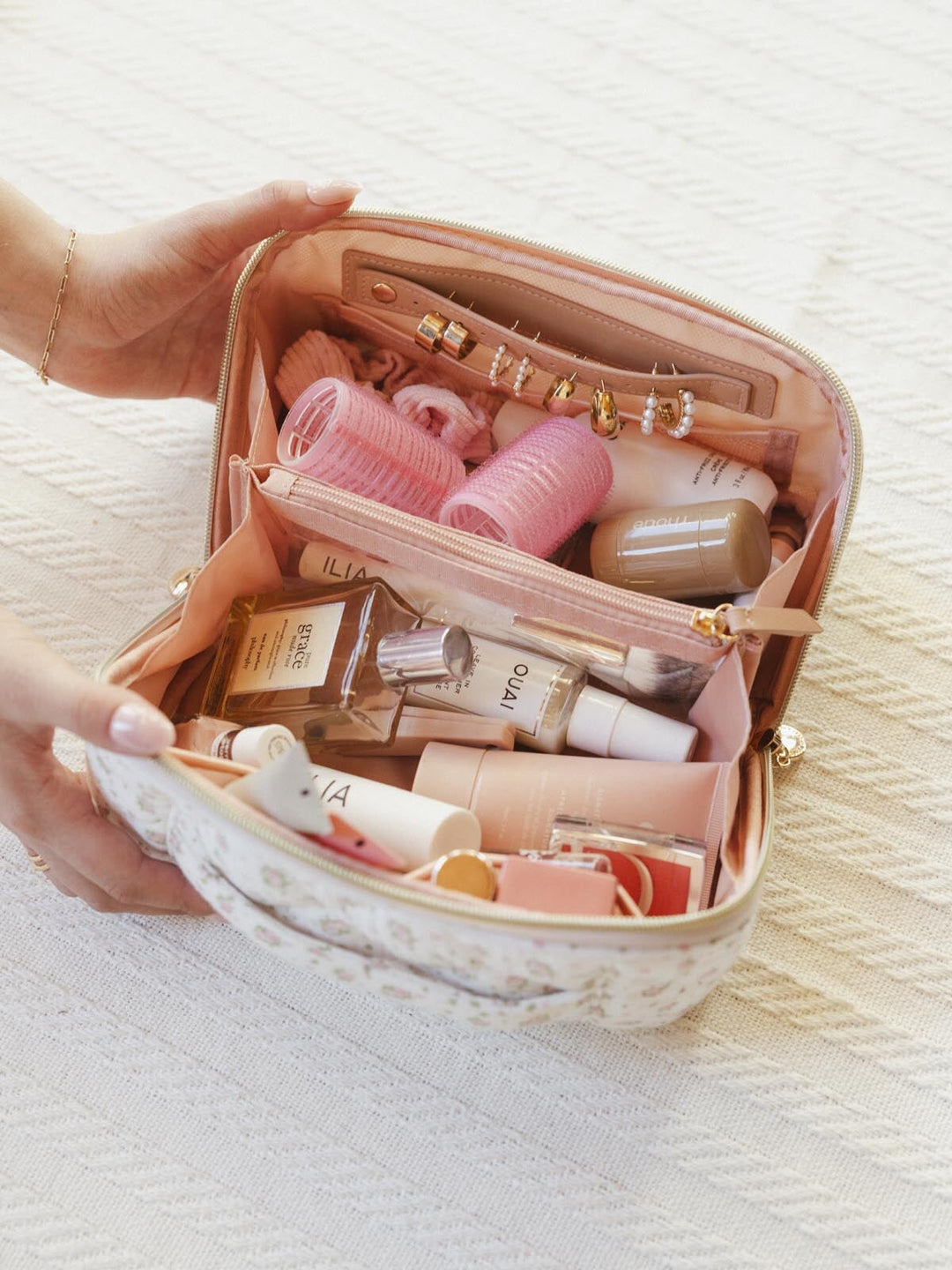 Open makeup bag full of beauty products 