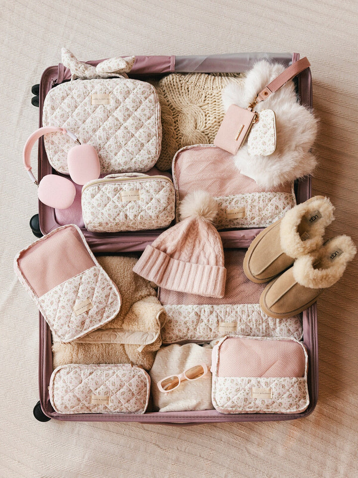 Floral-patterned packing cubes in a suitcase