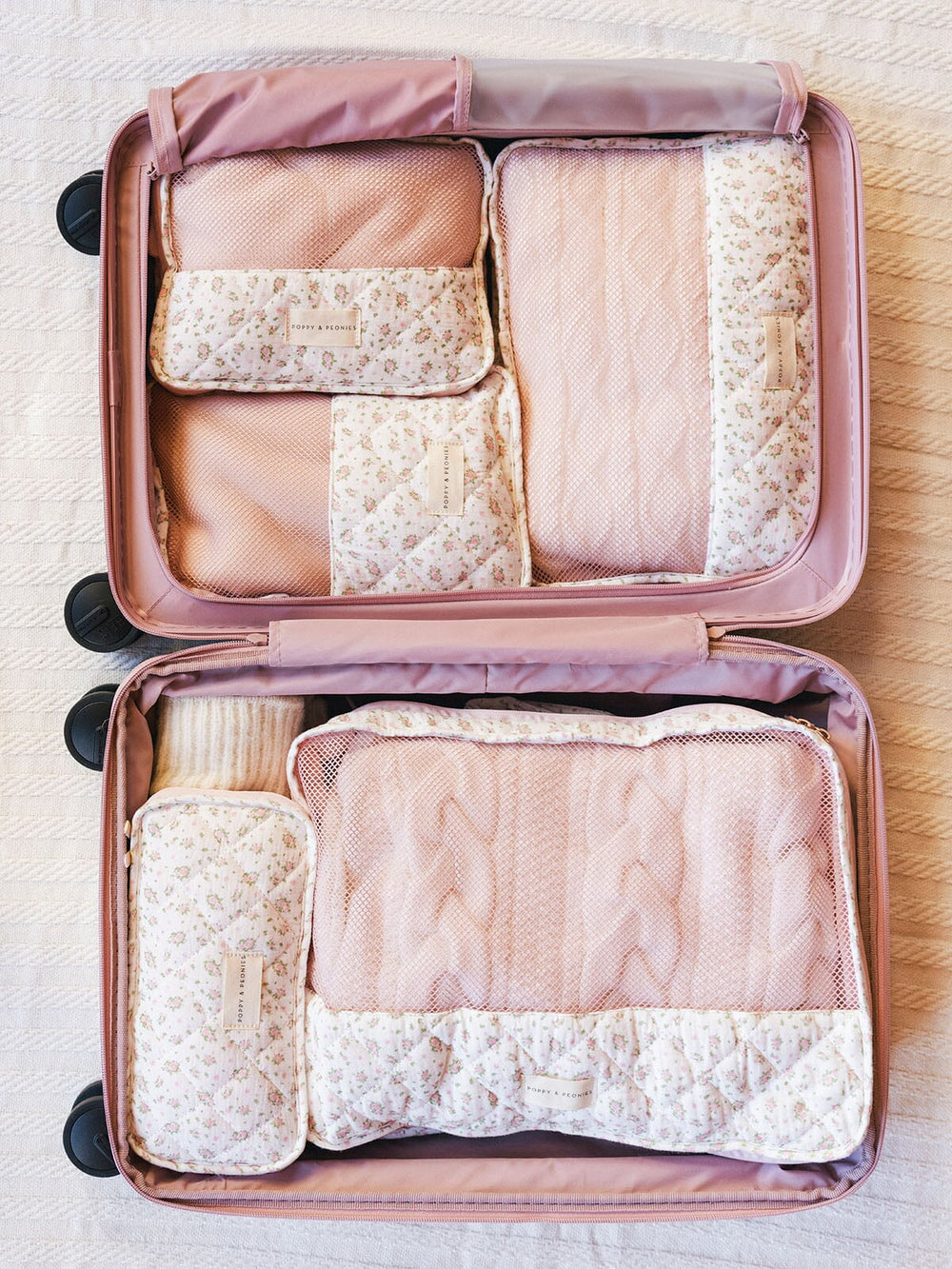 Floral-patterned packing cubes in a suitcase