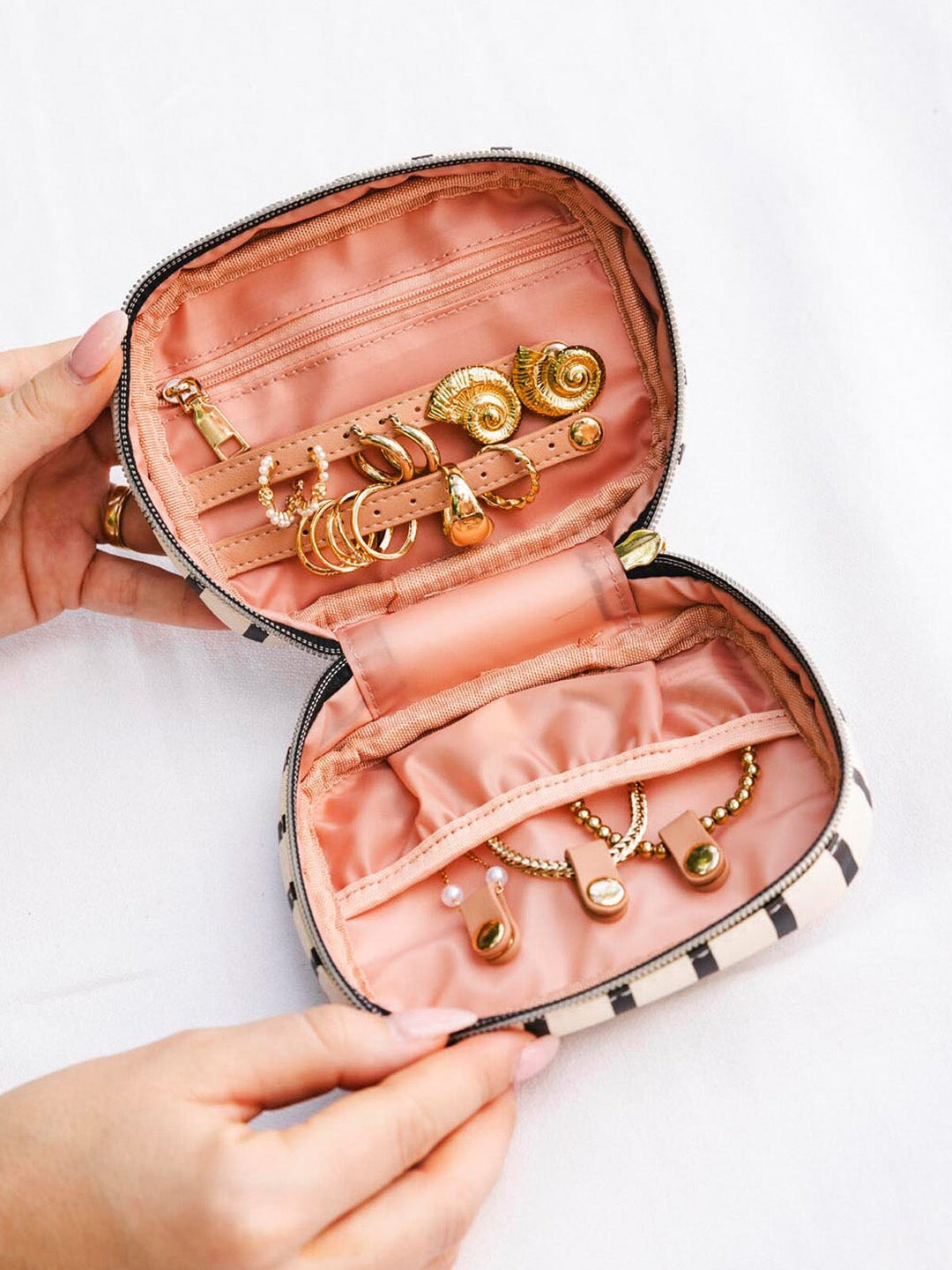 Open jewelry case with gold earrings and bracelets
