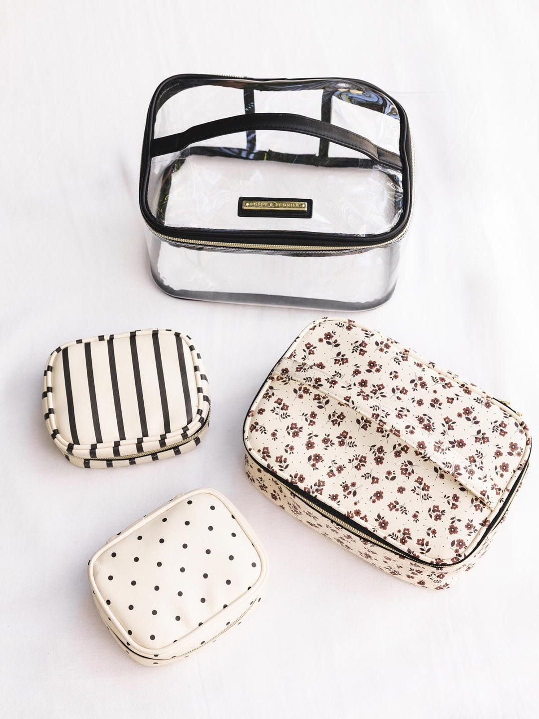 Set of four small cosmetic case with different patterns on a white background
