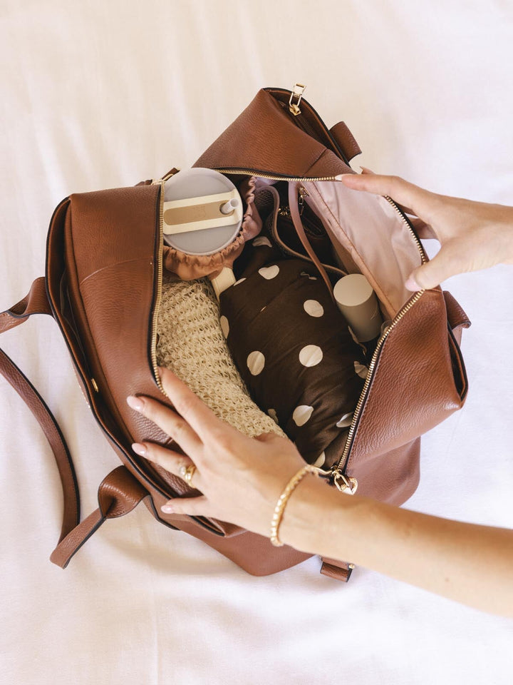 Neatly packed brown vegan leather duffle bag