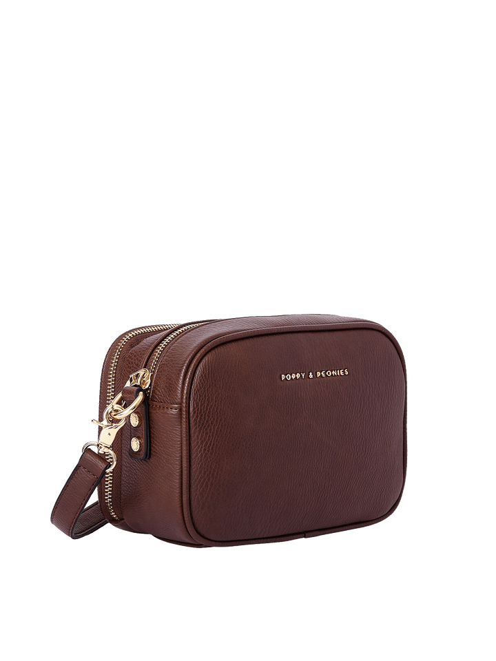 Angled view of the 24/7 Crossbody in Espresso showing structured vegan leather design