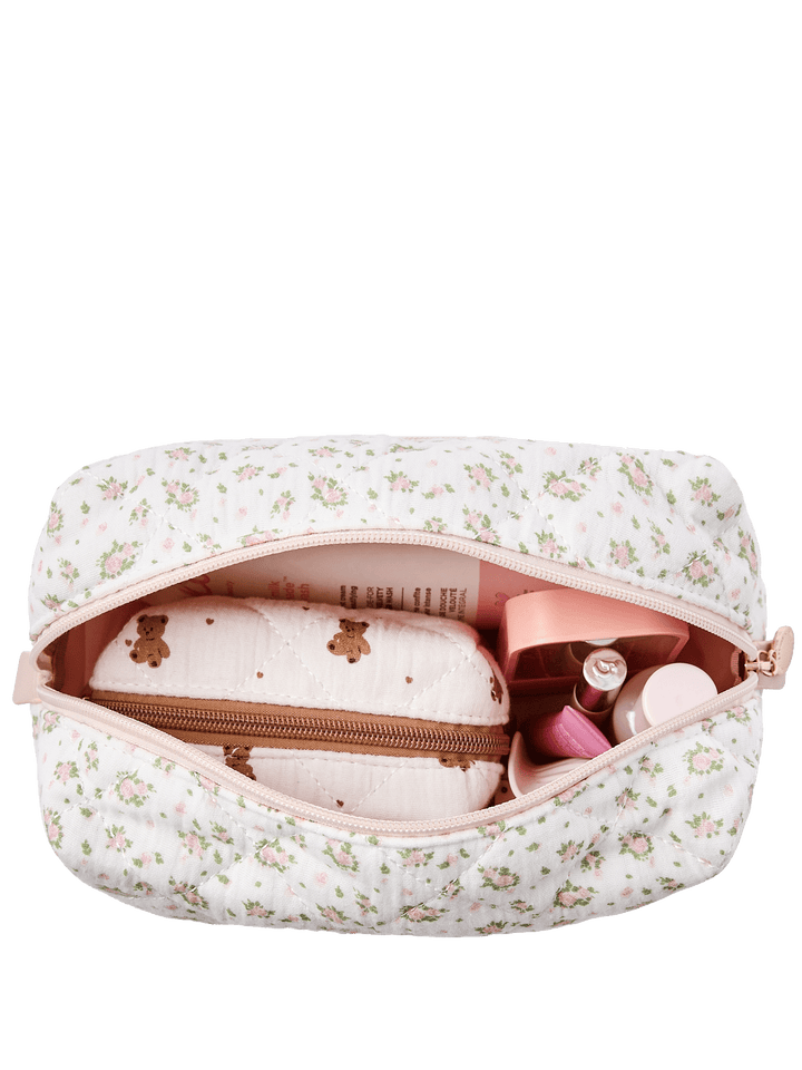 Floral-patterned makeup bag with cosmetic items in it