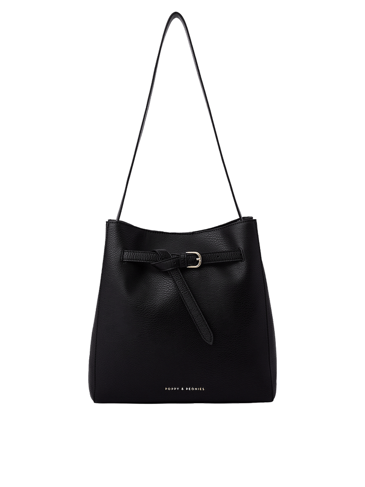 Poppy and Peonies The Knot Shoulder Bag Black featuring a structured silhouette with textured black material, a long shoulder strap, adjustable front buckle detail, gold-tone hardware, and subtle branding near the base.