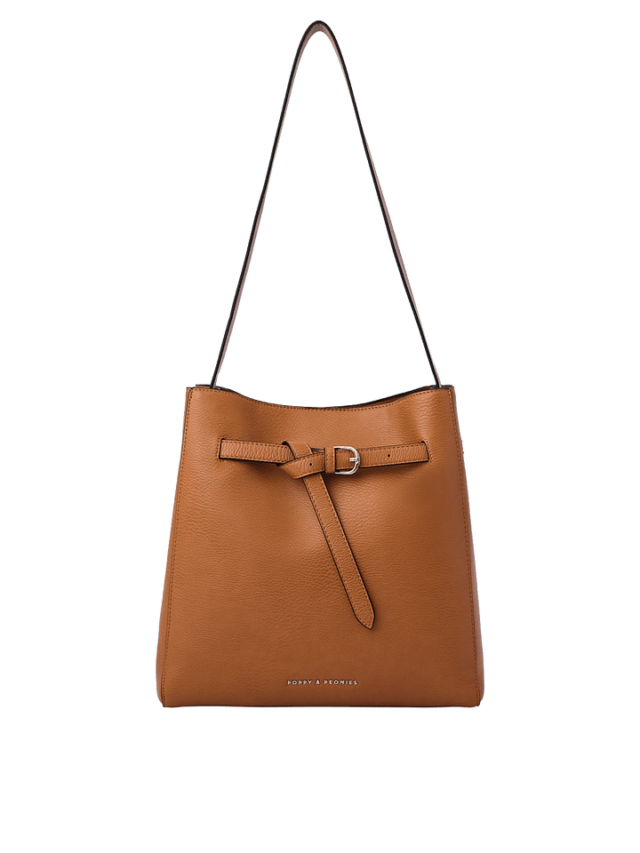 Poppy and Peonies The Knot Shoulder Bag Cognac featuring a structured bucket silhouette, pebbled texture, adjustable shoulder strap, decorative front buckle detail, and gold-tone hardware.