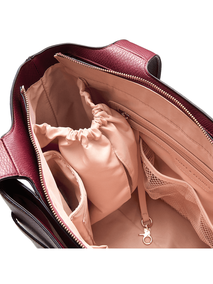 Open handbag revealing a pink interior