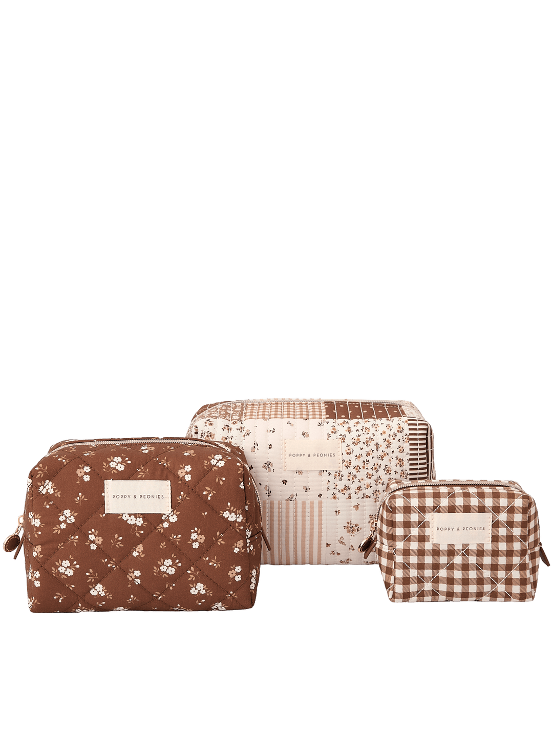Clean product shot of the Poppy & Peonies Cosmetic Trio in Brown Patchwork, featuring all three coordinating cosmetic cases together: a blue-and-white striped case, a brown patchwork case, and a navy floral case.